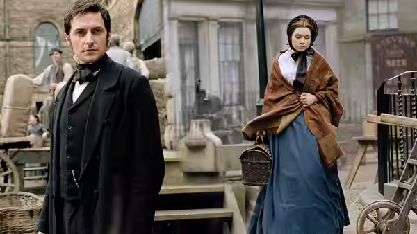 John Thornton (Richard Armitage) stands with Margaret Hale (Daniela Denby-Ashe) in an industrial yard