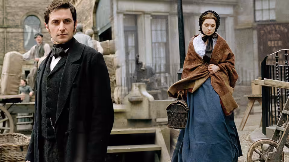 John Thornton (Richard Armitage) stands with Margaret Hale (Daniela Denby-Ashe) in an industrial yard