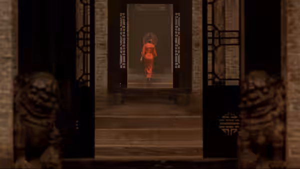 a woman in red walking through a traditional courtyard doorway