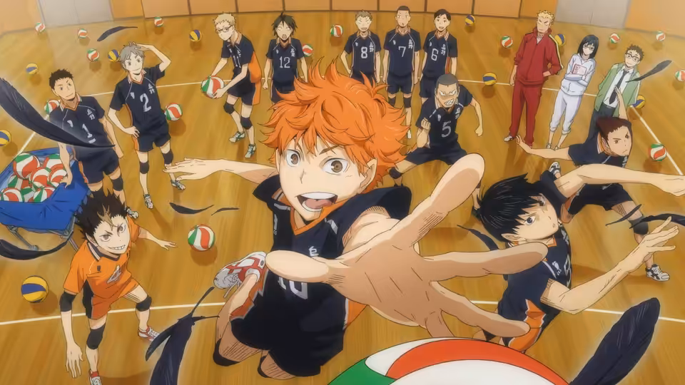 Shoyo Hinata (Ayumu Murase) reaches toward the volleyball as Karasuno players crowd the court
