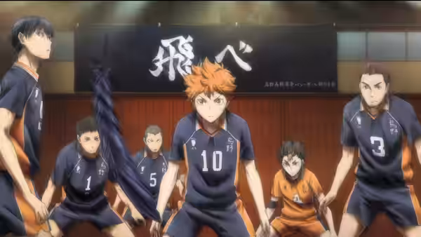 Shoyo Hinata (Ayumu Murase) stands with Karasuno teammates beneath a banner in the gym