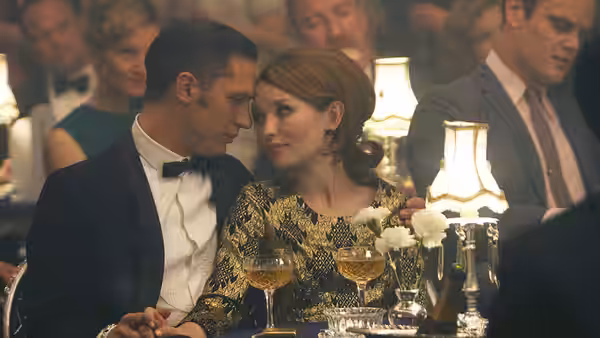 Reginald Kray (Tom Hardy) and Frances Shea (Emily Browning) share a drink at a party