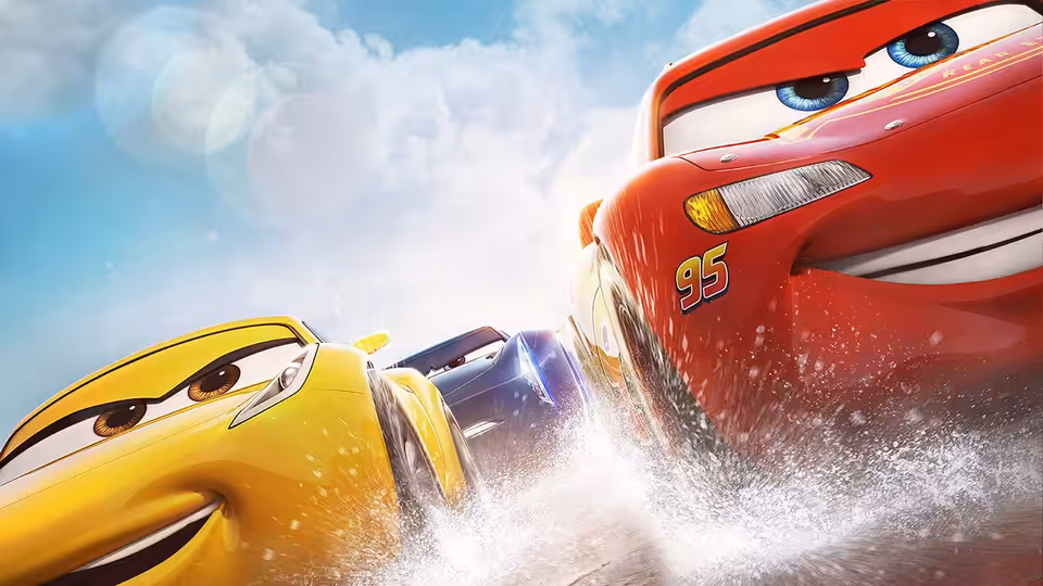 Lightning McQueen and Cruz Ramirez race side by side through a cloud of dirt