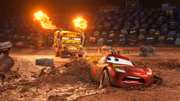 Lightning McQueen skids through a muddy training course as flames burst behind him