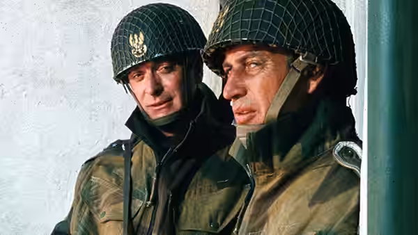 Col. Kurt Steiner (Michael Caine) stands beside a German soldier in a helmet