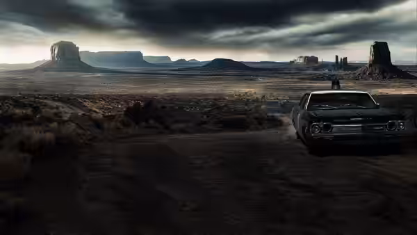 A dark car sits on a dirt road beneath storm clouds in the desert