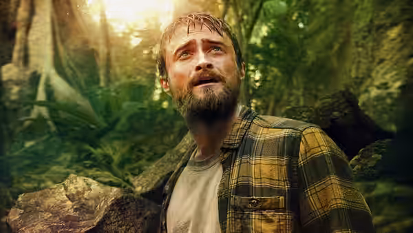 Yossi (Daniel Radcliffe) looks upward beneath the jungle canopy