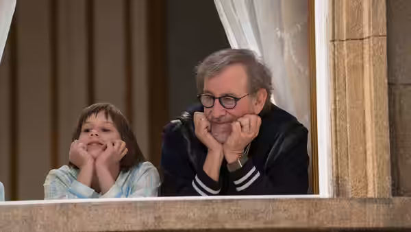 Sophie (Ruby Barnhill) and the BFG (Mark Rylance) rest their chins on their hands at a window