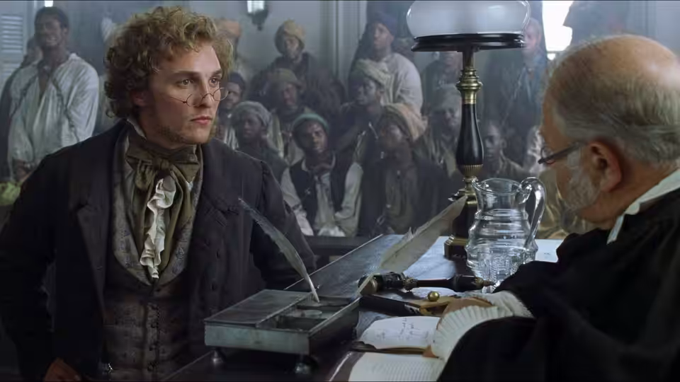 Roger Sherman Baldwin (Matthew McConaughey) speaks with a seated man across a desk