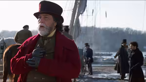 John Quincy Adams (Anthony Hopkins) stands at a harbor in a red coat