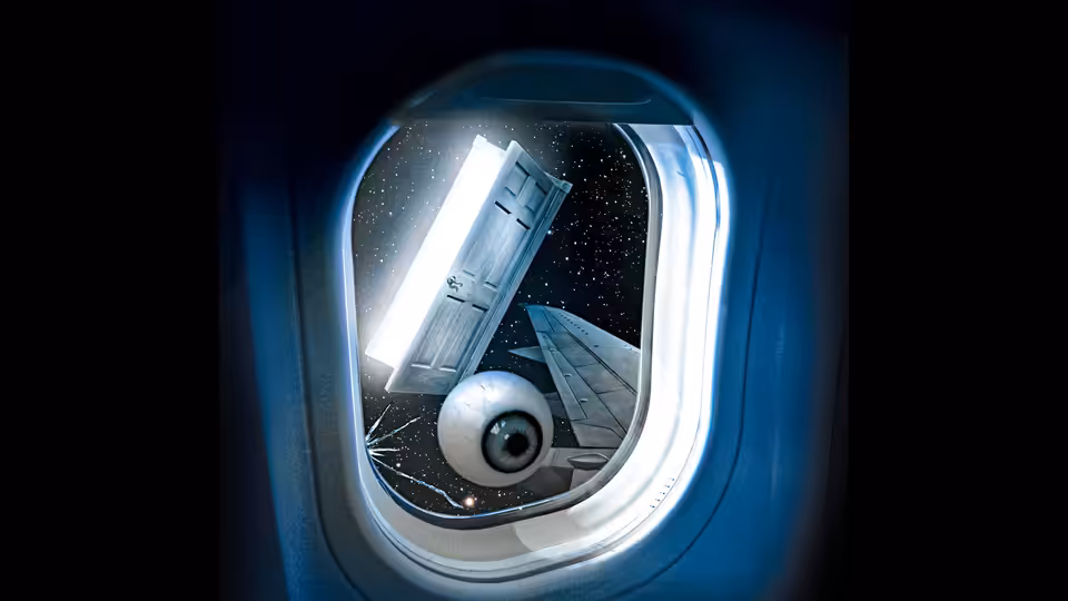 An airplane wing and engine seen through a passenger window against the night sky