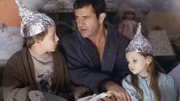 Graham Hess sits with Morgan and Bo in the kitchen, their heads covered in foil