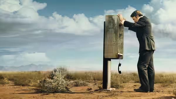 Jimmy McGill (Bob Odenkirk) uses an old outdoor phone booth in the desert