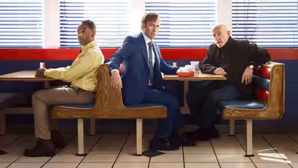 Jimmy McGill (Bob Odenkirk) sits in a diner booth between two men