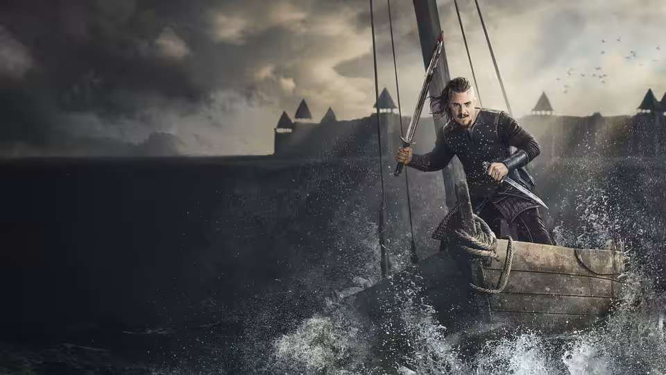 Uhtred of Bebbanburg (Alexander Dreymon) steers a small boat toward a fortified shoreline