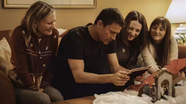 Jeffrey Manchester (Channing Tatum) and three women look at a tablet in a living room