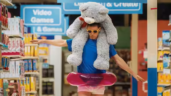 Jeffrey Manchester (Channing Tatum), wearing a stuffed animal hat and inflatable ring, stands in a toy store