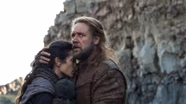 Noah (Russell Crowe) comforts Ila (Emma Watson) beside a rocky cliff