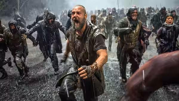 Noah (Russell Crowe) charges through a rain-soaked crowd as people flee around him