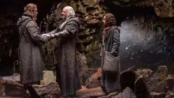 Methuselah (Anthony Hopkins) clasps Noah's hands in a rocky cave as Ham watches