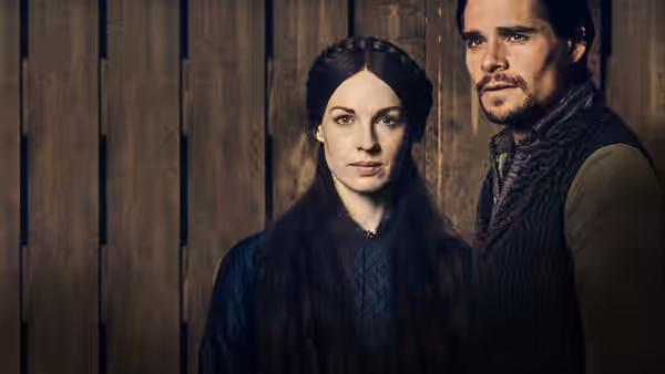 Annie Quaintain (Jessica Raine) and Johnny Jackson (Hans Matheson) standing together indoors