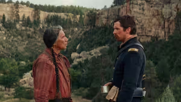 Chief Yellow Hawk (Wes Studi) faces Captain Joseph J. Blocker (Christian Bale) outside a stone building