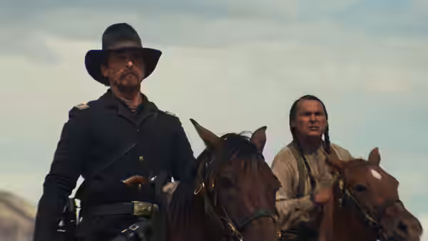 Captain Blocker (Christian Bale) rides beside Black Hawk (Adam Beach) across open country