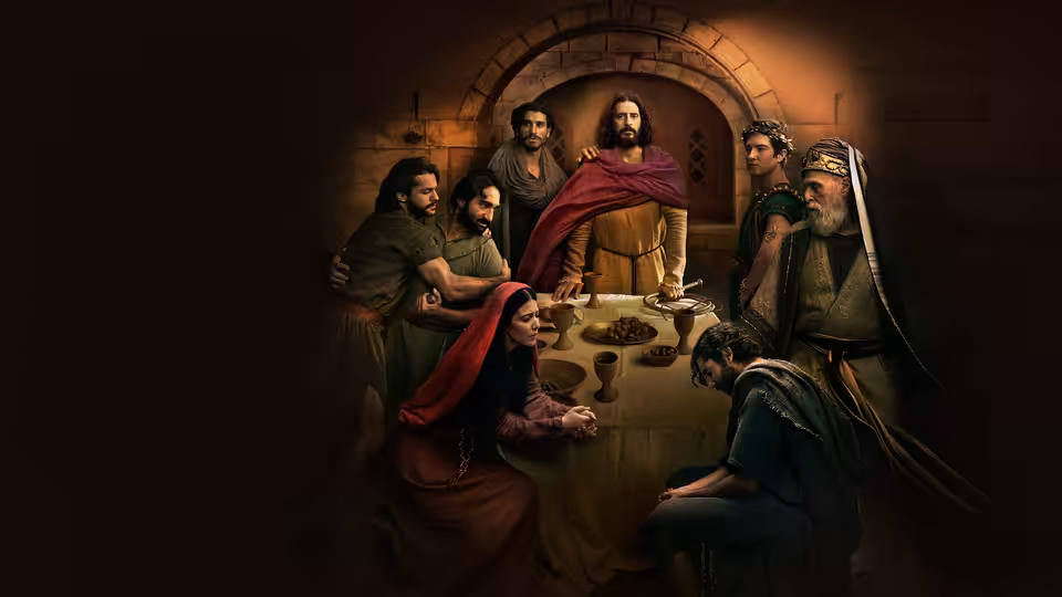 Jesus (Jonathan Roumie) shares a meal with his followers around a table