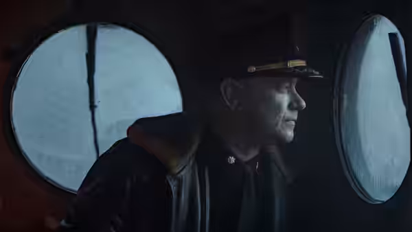 Commander Krause (Tom Hanks) looks out through a porthole aboard the ship