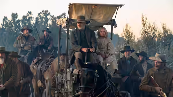 Captain Jefferson Kyle Kidd and Johanna ride in a covered wagon with armed escorts