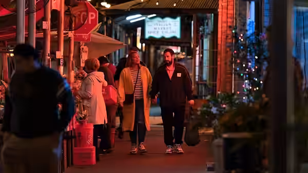 Stanley Sugerman (Adam Sandler) and Teresa Sugerman (Queen Latifah) walk through a busy venue