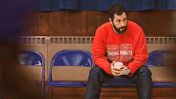 Stanley Sugerman (Adam Sandler) sits alone on a gym bench, holding a phone