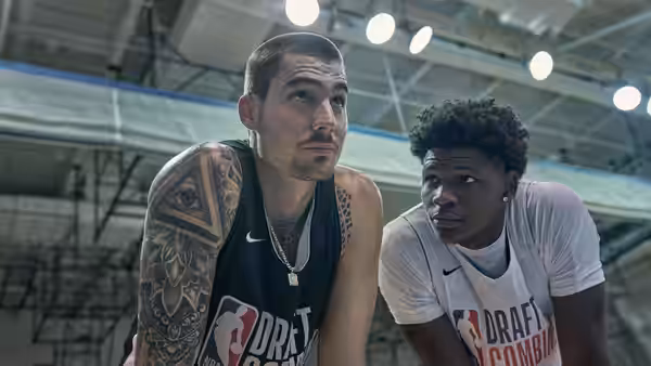 Bo Cruz (Juancho Hernangómez) and another player lean forward courtside, watching the action