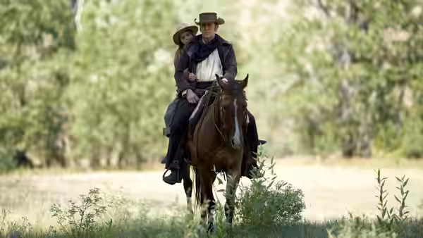 Colton Briggs (Nicolas Cage) and Brooke Briggs (Ryan Kiera Armstrong) ride together through a meadow