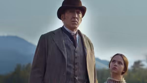 Colton Briggs (Nicolas Cage) stands beside Brooke Briggs (Ryan Kiera Armstrong) against a mountain backdrop