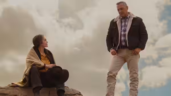 Margaret (Diane Lane) sits on a rock while George Blackledge (Kevin Costner) stands nearby