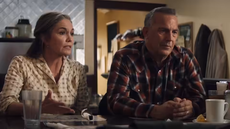 Margaret (Diane Lane) and George Blackledge (Kevin Costner) sit at a table indoors