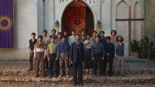 A man stands before a church with a group of young men