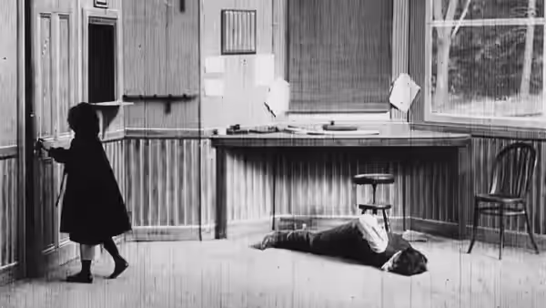 A girl enters the station office beside a man lying on the floor