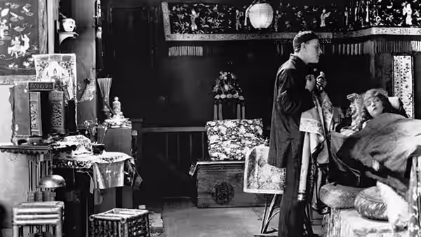 Cheng Huan (Richard Barthelmess) stands beside Lucy Burrows (Lillian Gish) in bed