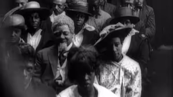 A seated crowd of men and women faces forward in a gathering