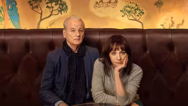 Felix (Bill Murray) and Laura (Rashida Jones) sit together in a booth