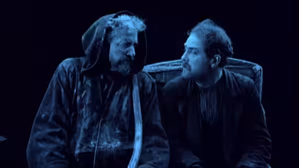David Holm sits beside a hooded carriage driver inside a carriage