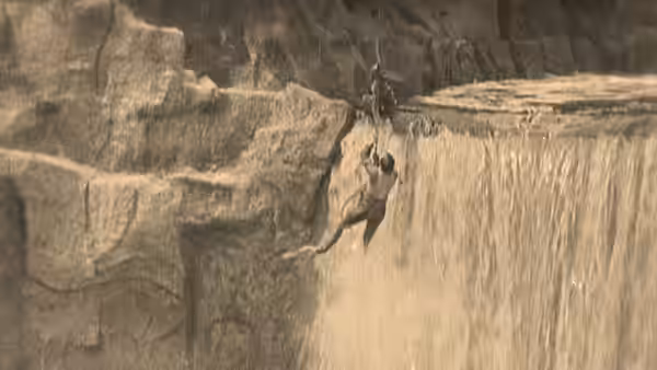 William McKay (Buster Keaton) clings to the edge of a waterfall as water plunges below