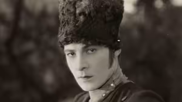 Lt. Vladimir Dubrovsky (Rudolph Valentino) wearing a tall fur hat and military uniform