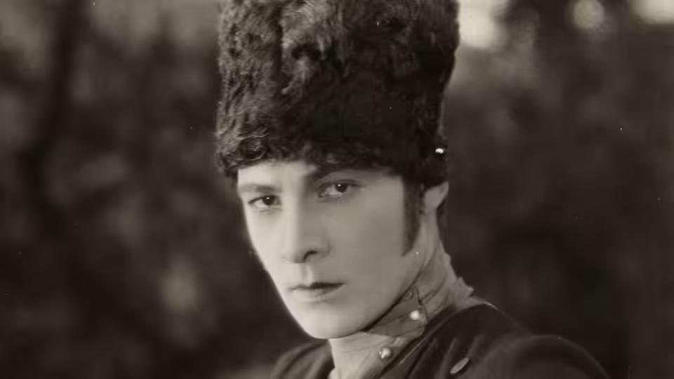 Lt. Vladimir Dubrovsky (Rudolph Valentino) wearing a tall fur hat and military uniform