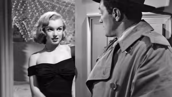 A woman in an evening dress faces a uniformed man by a doorway