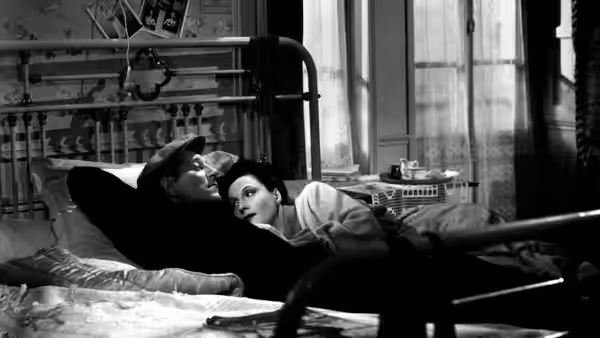 Françoise leans over François as he lies in bed