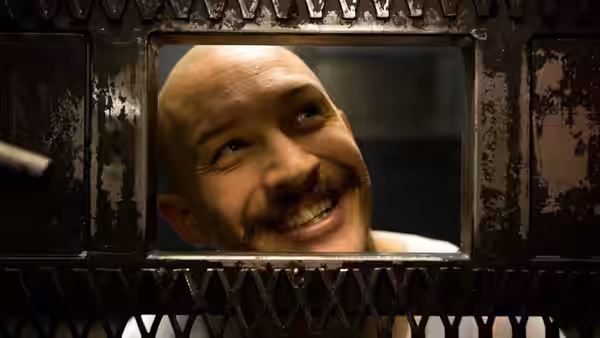 Michael Peterson (Tom Hardy) smiles through a small barred window
