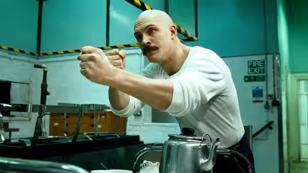 Charles Bronson (Tom Hardy) aims a utensil across a prison kitchen